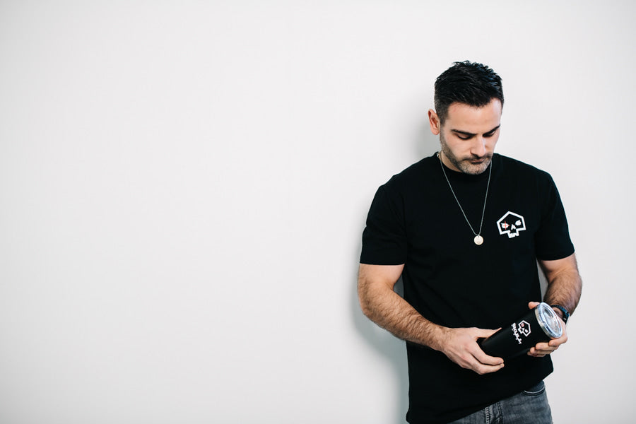 Man holding Corkcicle Tumbler SkullRobot